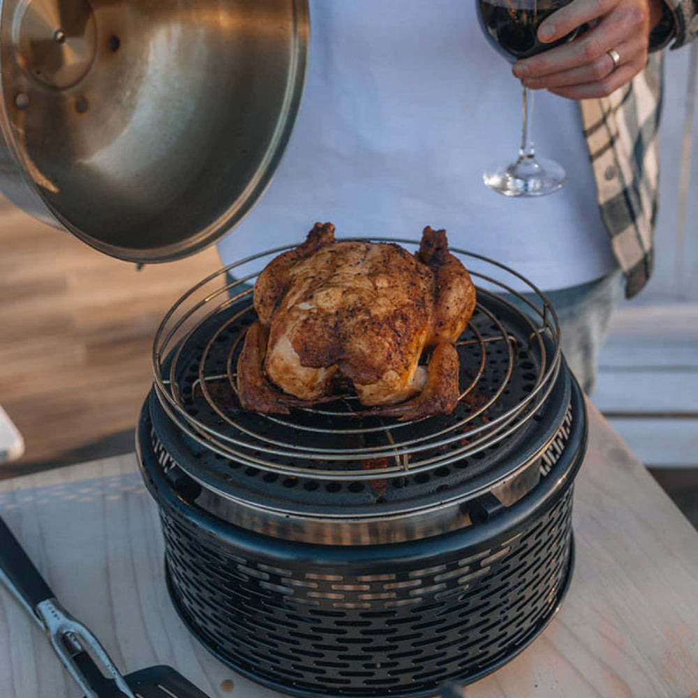 COBB Portable cooker with roasting rack on top cooking a roast chicken
