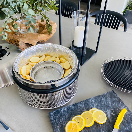 COBB silver foil inner sleeves in a COBB grill with potatoes inside