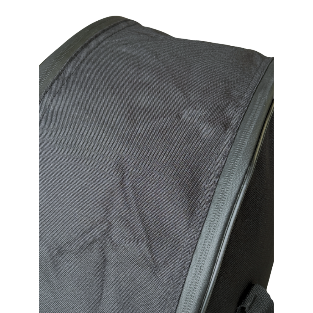 Close-up of a black fabric bag or backpack corner with a zipper, shown against a plain white background.