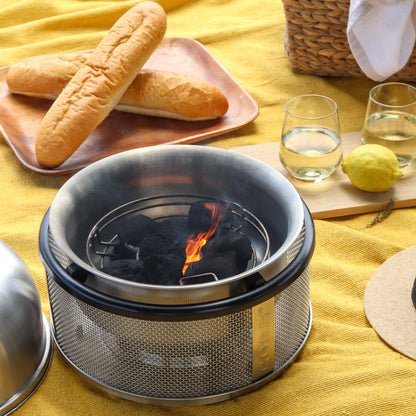 COBB Portable Cooker Picnic setup with bread, glasses, and a COBB BBQ Kit fired up on a yellow blanket 