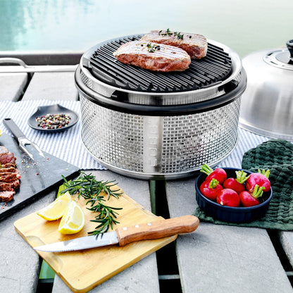 COBB Portable Outdoor Cooker with steak on river bank