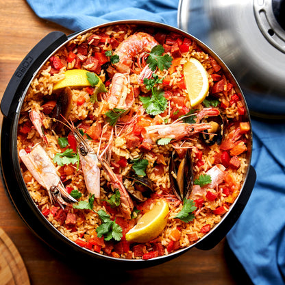 COBB Portable cooker with Paella dish in the cobb fry dish on a wooden table.