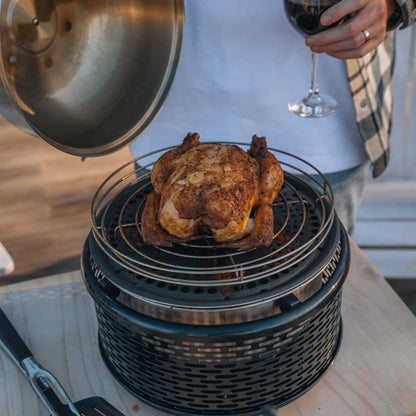 COBB Portable cooker with roasting rack on top cooking a roast chicken