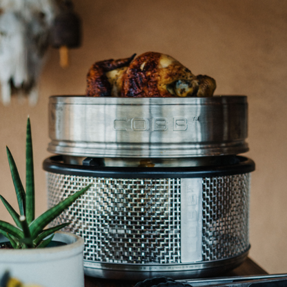 COBB portable cooker with dome extension cooking roast chicken