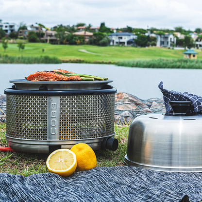 COBB portable gas cooker on grass river bank cooking salmon