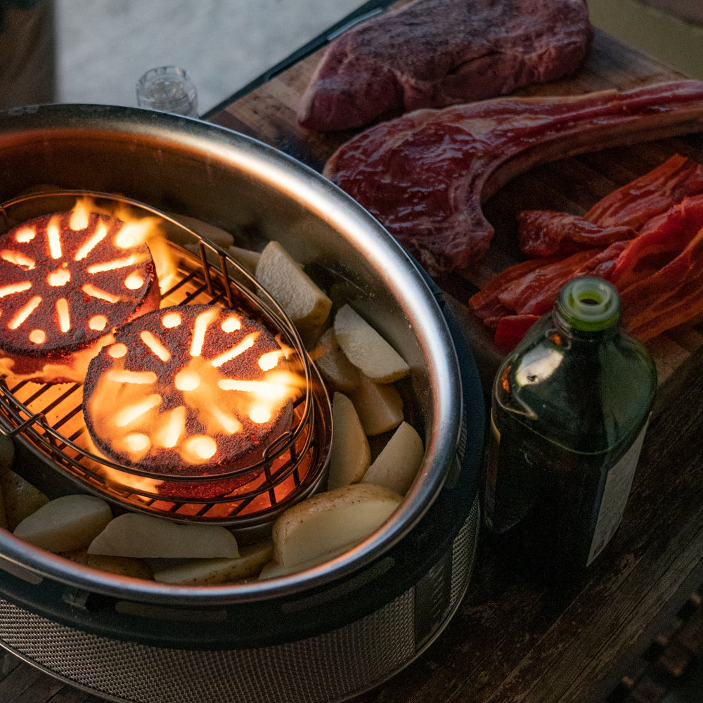Cobb grill cooker with two charcoal Cobble Stone burning 