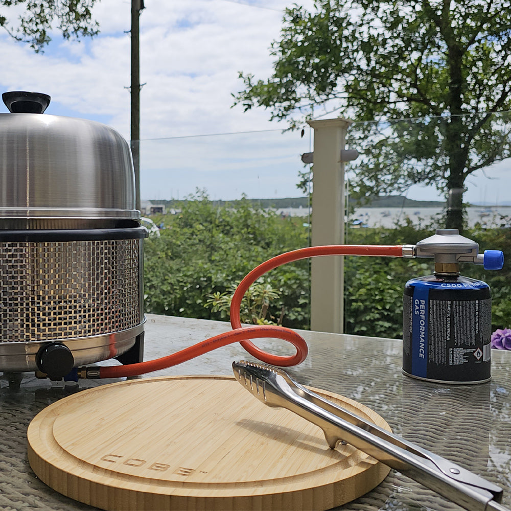 Gas regulator and hose connected to a COBB BBQ
