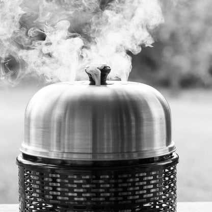 Smoking COBB PRO GRILL on a wooden surface with a blurred background
